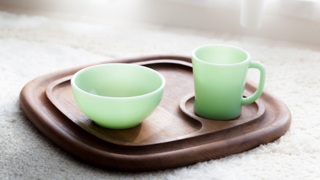 Pale blue jadeite mug and bowl on a wooden tray